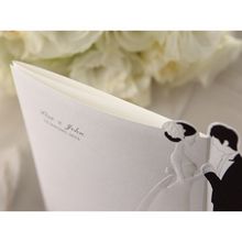 Black and white trifold wedding invitation; bride and groom embossed design; top view